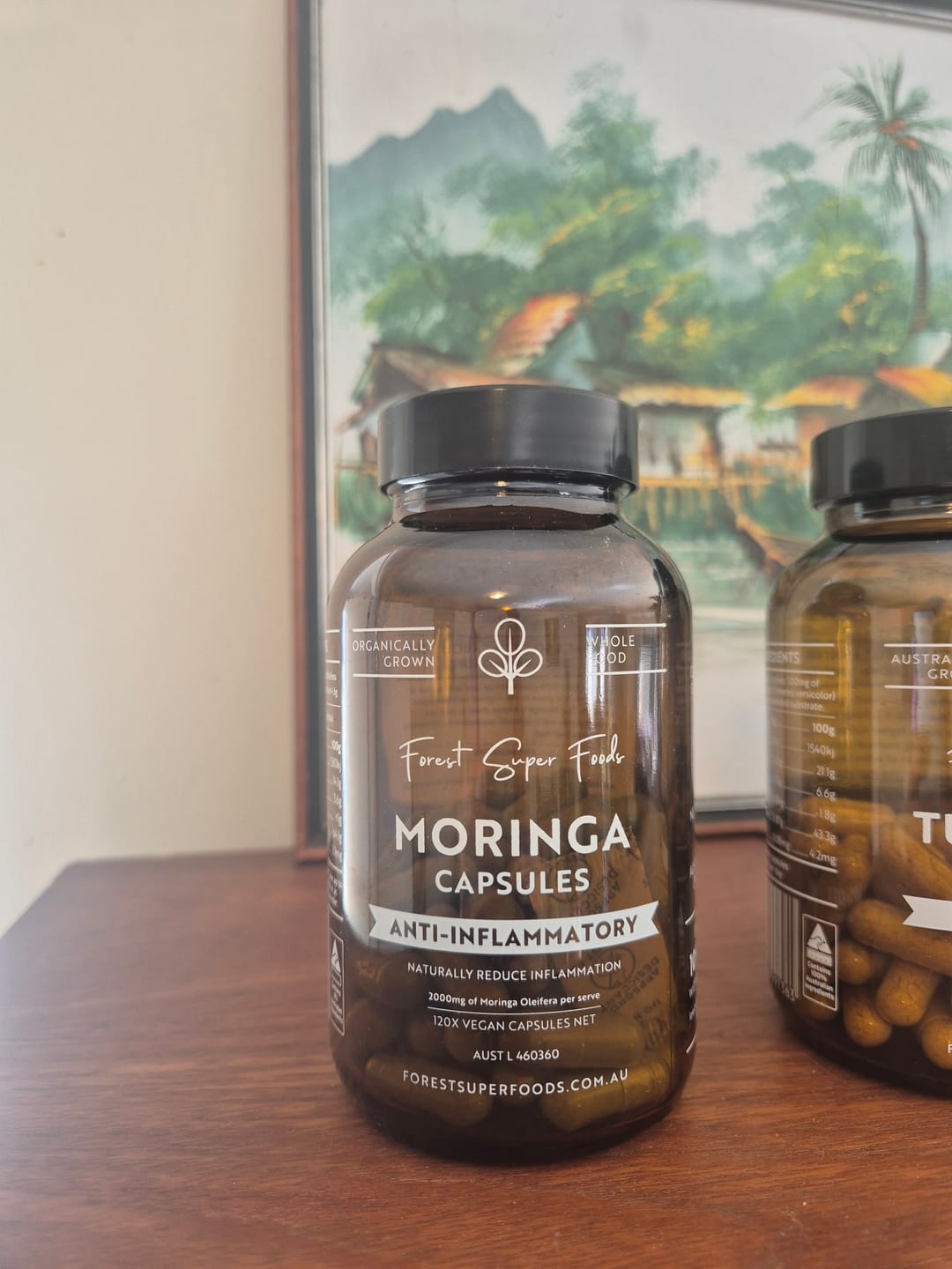 Customer holding a bottle of Organic Moringa Capsules.